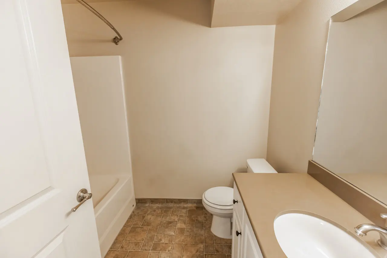 A bathroom with a toilet, sink, and bathtub